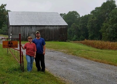 Duley Family standing beside farm sign.