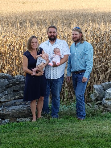 Shank family photo infront of corn field.